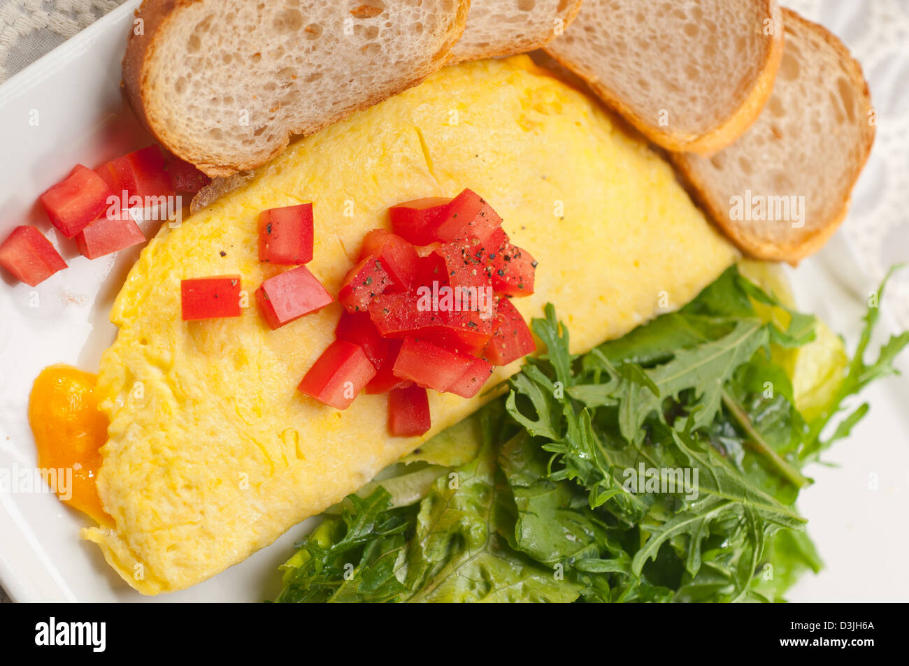 home made omelette with cheese tomato and rucola rocket salad arugola Stock Photo