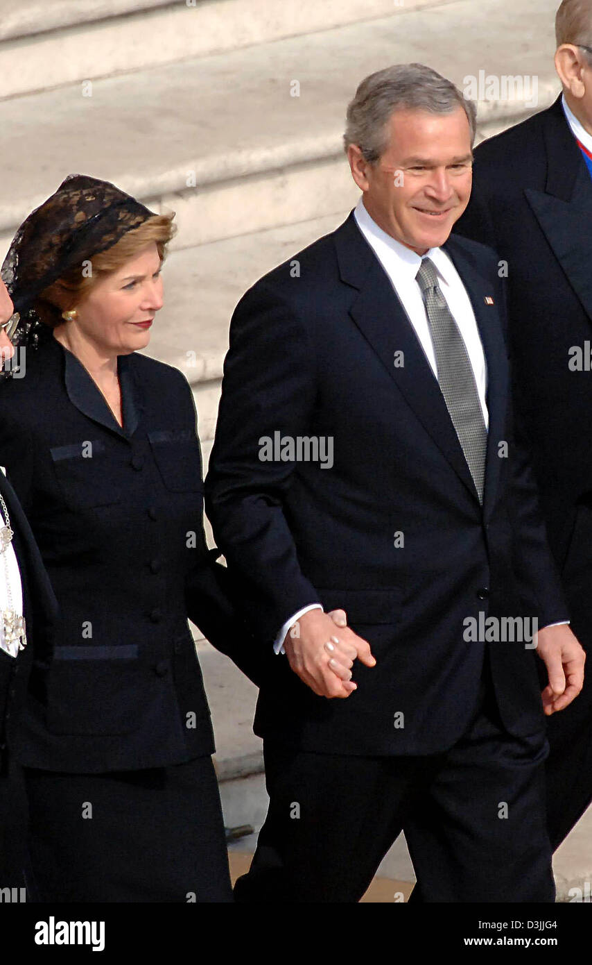 (dpa) - US President George W. Bush walks hand in hand with his wife Laura to his seat at the start of the funeral service for Pope John Paul II at Saint Peter's Square in the Vatican, Vatican City State, 8 April 2005. Among the guests are more than 200 state and government leaders from all over the world. The Pope died at the age of 84 last Saturday. Stock Photo