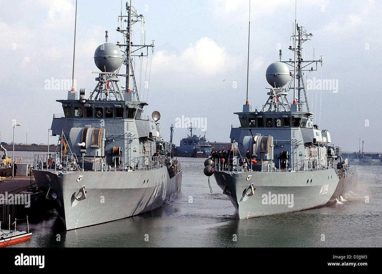 (dpa) - A minesweeper of the German navy (R) leaves while another minesweeper (L) stays at the navy base Olpenitz, Germany, 7 April 2005. Ten ships of the German navy participate in the NATO manoeuvre 'Loyal Mariner'. The manoeuvre takes place with 85 ships and 30 airplanes from 19 states at the Baltic Sea between 11 and 29 April. Stock Photo