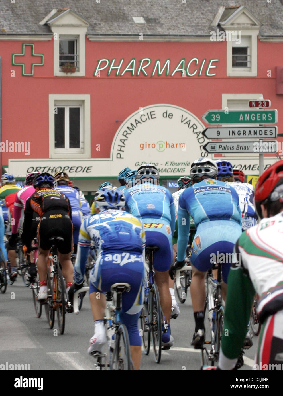 German Rinding Bycicles Cycling pros ride their bicycles past a pharmacy shortly after the ...