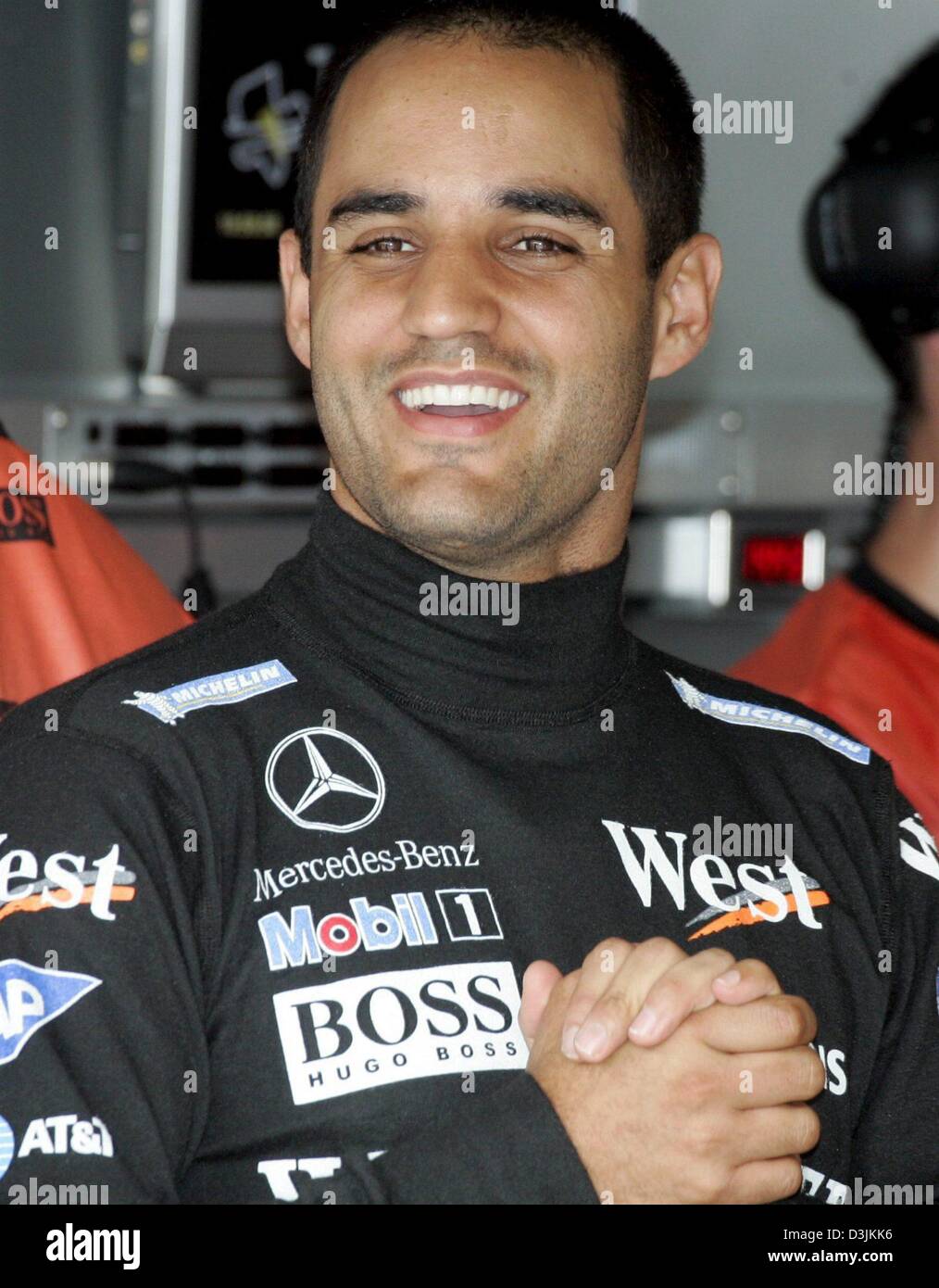 (dpa) - Colombian Formula One driver Juan Pablo Montoya of McLaren Mercedes laughs in his pit during a practice session at the Malaysian Grand Prix circuit in Sepang, near Kuala Lumpur, Malaysia, Friday 18 March 2005. Montoya clocked the second fastest time. The Grand Prix of Malaysia takes place on Sunday 20 March 2005. Stock Photo