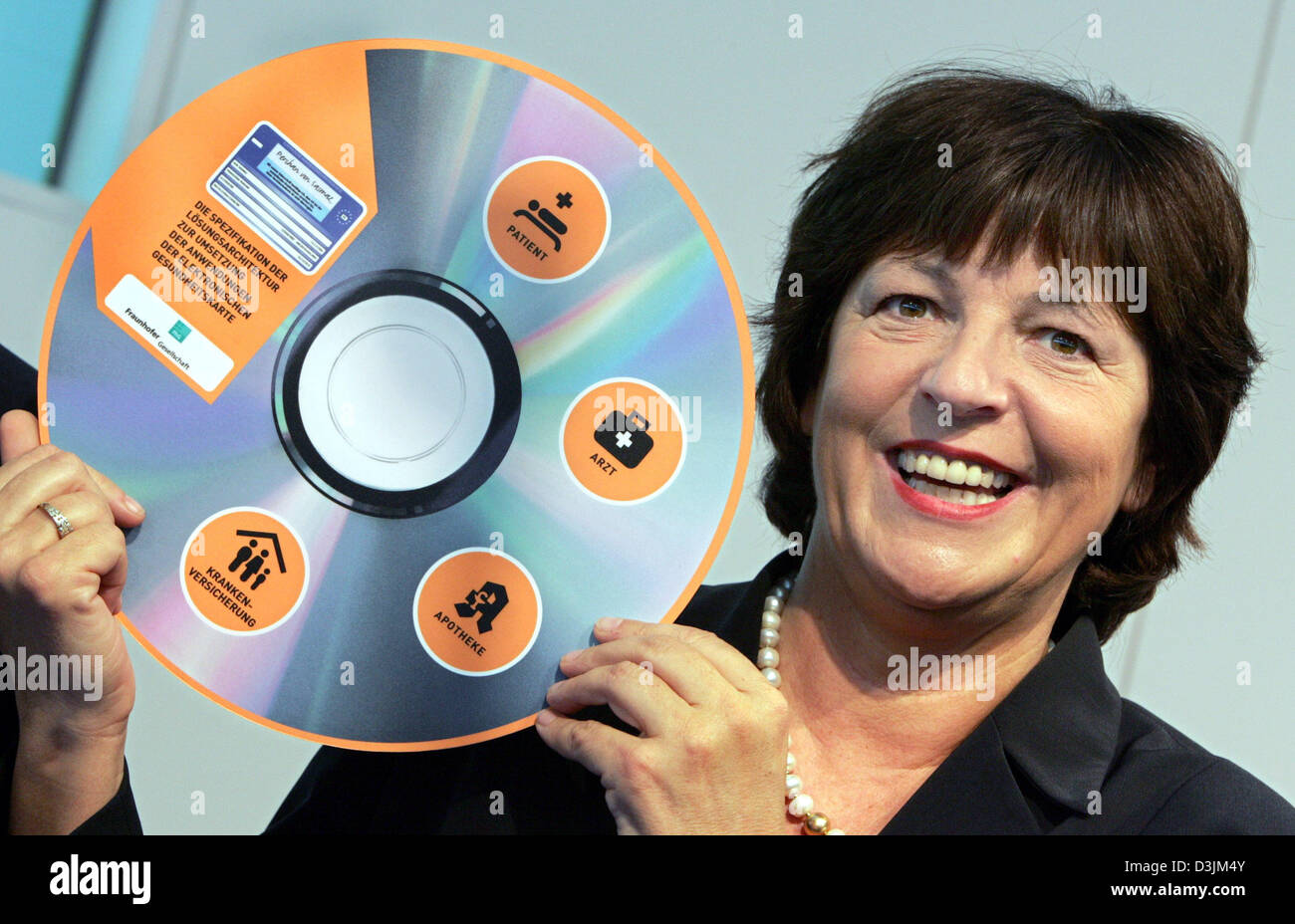 (dpa) - Ulla Schmidt, German Minister for Health and Social Issues, presents the solution architecture for the electronical health card in form of a gigantic CD at the world's largest computer fair CeBIT in Hanover, Germany, 14 March 2005. The planned electronical health card takes on further shape. Prior to the event the Fraunhofer institute for software and system technology gave Stock Photo