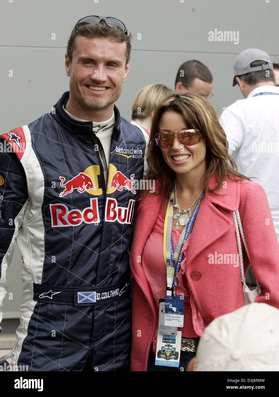 (dpa) - British Formula One driver David Coulthard (L) and Australian singer Dannii Minogue smile as they meet in the paddock at the Grand Prix circuit in Albert Park in Melbourne, Australia, 06 March 2005. He droped out of the the race after a collision with the German BMW-Williams driver Nick Heidfeld. Stock Photo