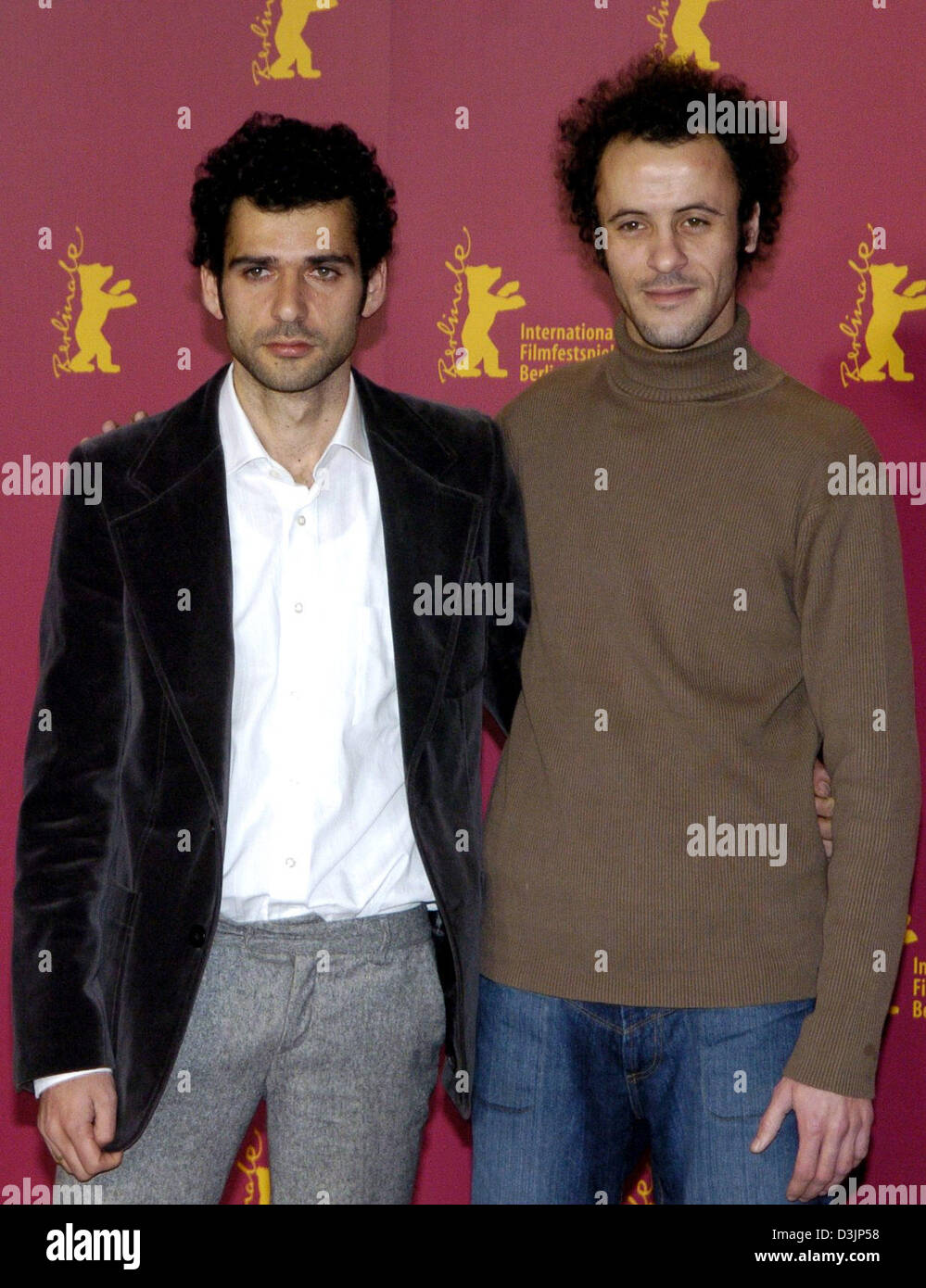 (dpa) - Palestinian actors Kais Nashif (L) and Ali Suliman smile during the press conference for their movie 'Paradise Now ' at the Berlinale Filmfestival in Berlin, Germany, 14 February 2005. The German-Dutch-French production centres around a young Palestinian woman and the search for her groom. Stock Photo