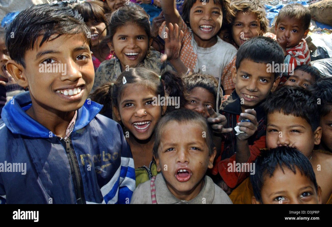 (dpa) - Numerous girls and boys gather in a crowd and cheer and smile for a group picture in a slum on the outskirts of metropolitan Delhi, India, 02 February 2005. While modern high-rises are being built in the business districts of India's inner cities, countless Indians still live in poverty in a country with more than one billion people. Despite the legal abolition of the caste Stock Photo