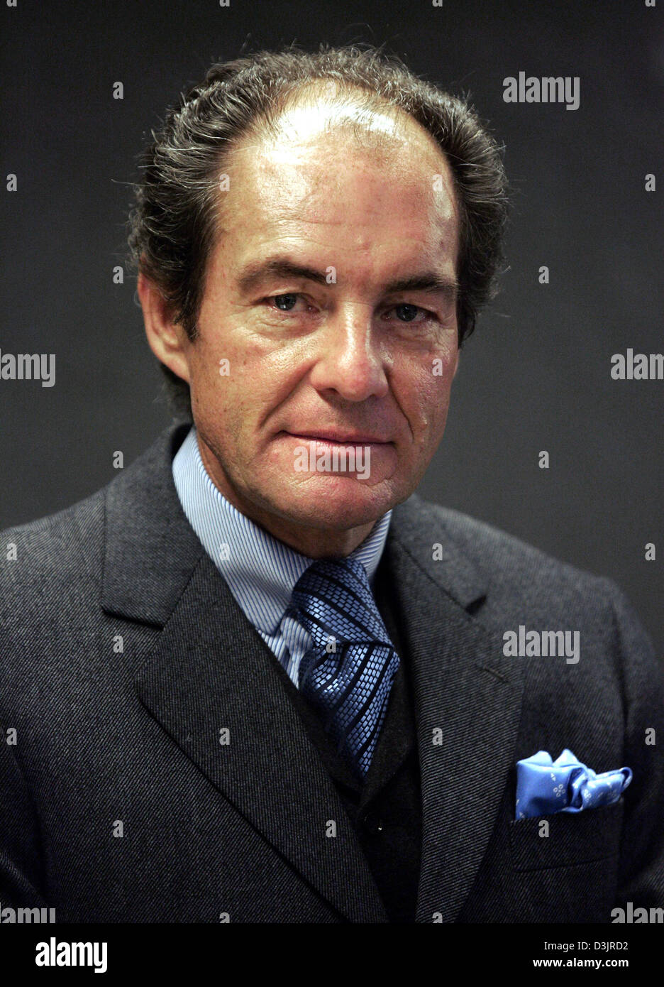 (dpa) - Georg Riedel, business manager of Riedel Tiroler Glashuette, manufacturer of wine glasses, poses for a picture in Munich, Germany, 25 January 2005. After the takeover of Nachtmann, manufacturer of lead crystal,  Riedel is now going to ax around 500 jobs. Nachtmann is going to cut around 400 jobs and Riedel around 100 jobs by 2006 in order to lower the costs and limit the lo Stock Photo