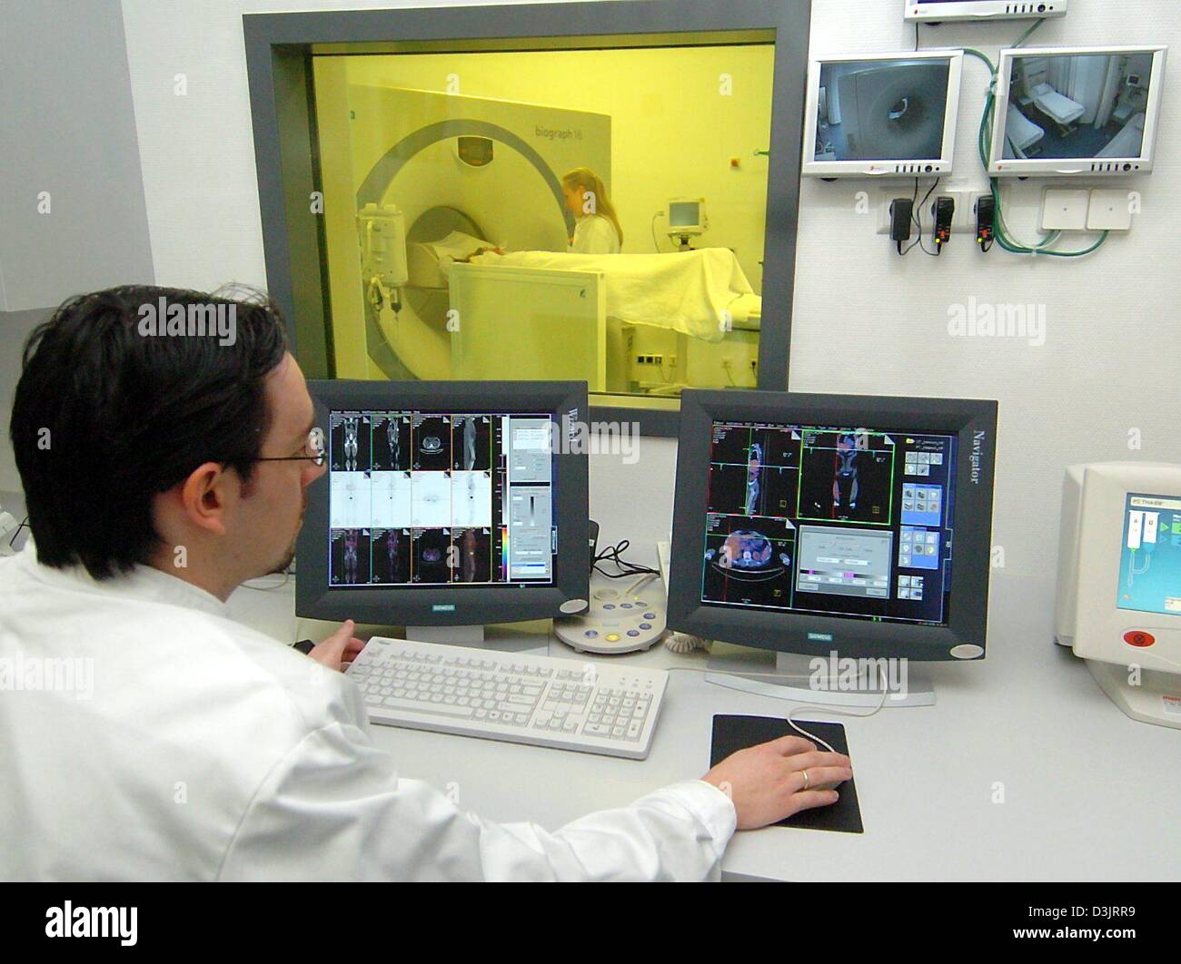 (dpa) - Medical doctor Magnus Klein observes the use of Europe's most modern positronic emission tomograph in a staged scene at the University Clinic in Tuebingen, Germany, 21 January 2005. The building cost of the machine developed by Siemens lies at 710,000 euros. The improvement in the machine is its capability to work with a higher resolution. Stock Photo