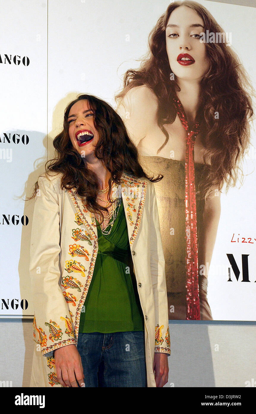(dpa) - Lizzy Jagger, daughter of former model Jerry Hall and British singer Mick Jagger of the Rolling Stones, smiles as she stands in front of an advertising poster featuring herself in Berlin on Thursday 20 January 2005. The British top model is advertising for the Spanish fashion house Mango. Stock Photo