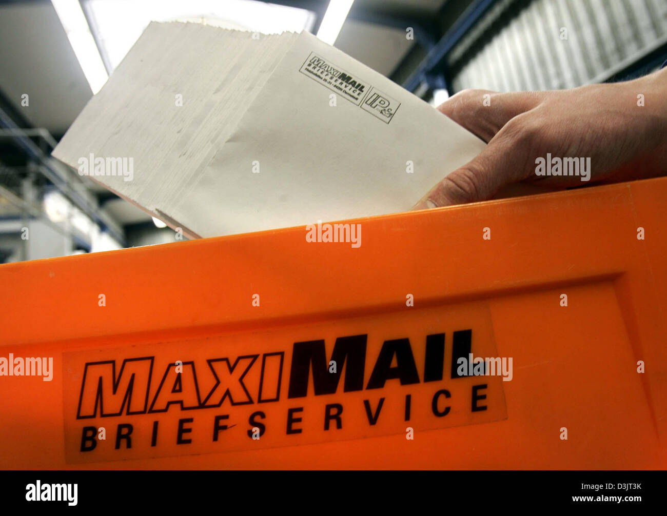 (dpa) - An employee of private German postal service MaxiMail manually sorts letters in Darmstadt, Germany, 13 January 2005. About 50,000 to 80,000 letters are handled by MaxiMail in Darmstadt every day. Stock Photo