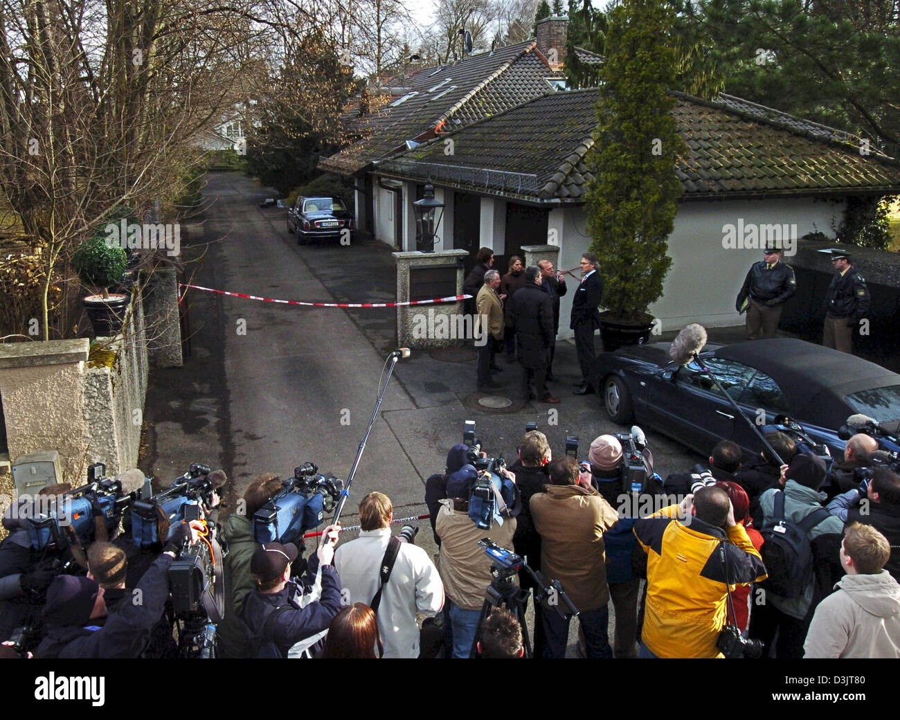 (dpa) - Numerous journalists wait in front of the mansion of fashion designer Rudolph Moshammer who was found dead in his house earlier this morning in Gruenwald near Munich, Germany, 14 January 2005. In the right background stands the Rolls Royce with Moshammer's initials. According to first results of the investigation a violent death has not been excluded. Stock Photo