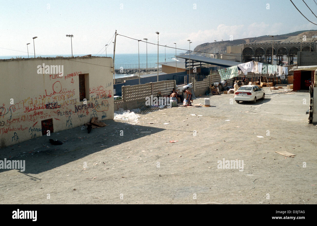 (dpa) - A view at the border crossing (back) between Morocco and the Spanish exclave of Ceuta, 9 September 2004. The harbour town of Ceuta at the north western tip of Morocco belongs to Spain since 1580. Stock Photo