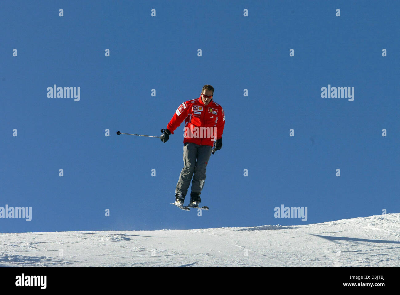 (dpa) - Seven time Formula 1 champion Michael Schumacher (team Ferrari) jumps as he skis down the slopes shortly after arriving in the ski resort of Madonna di Campiglio, Italy, 11 January 2005. The Ferrari team got together for its traditional ski vacation in the Italian Alps. (ITALY OUT) Stock Photo