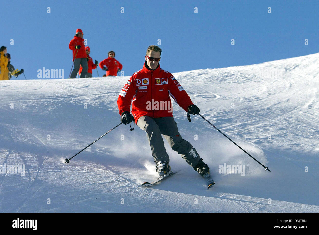 (dpa) - Seven time Formula 1 champion Michael Schumacher (team Ferrari) skis down the slopes shortly after arriving in the ski resort of Madonna di Campiglio, Italy, 11 January 2005. The Ferrari team got together for its traditional ski vacation in the Italian Alps. (ITALY OUT) Stock Photo