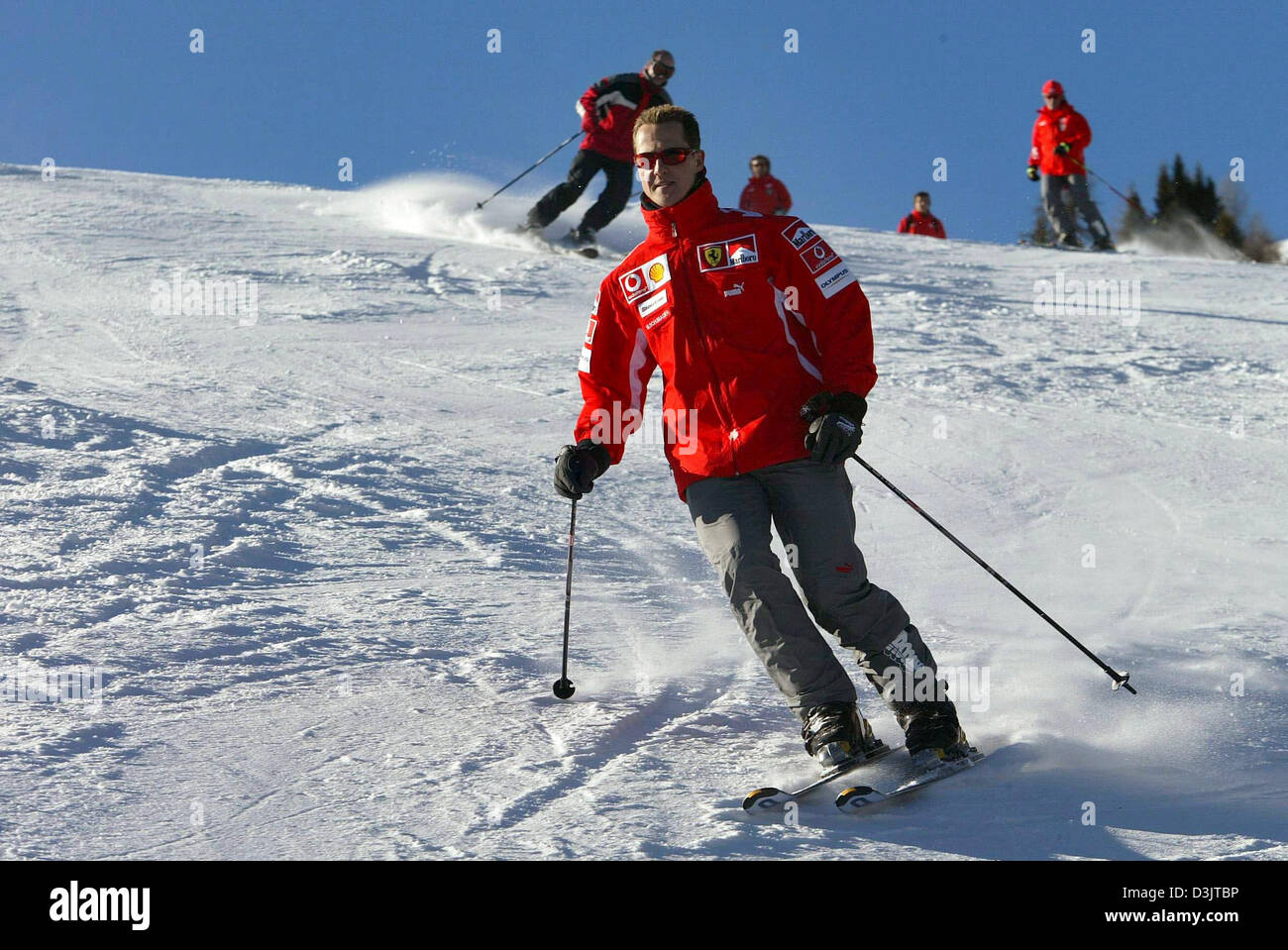 (dpa) - Seven time Formula 1 champion Michael Schumacher (team Ferrari) skis down the slopes shortly after arriving in the ski resort of Madonna di Campiglio, Italy, 11 January 2005. The Ferrari team got together for its traditional ski vacation in the Italian Alps. (ITALY OUT) Stock Photo