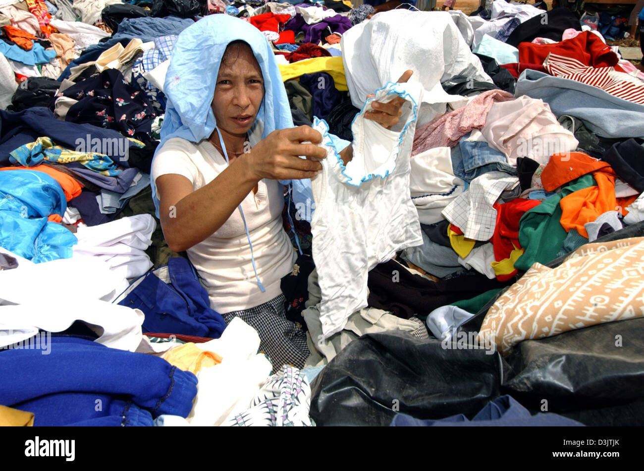 dpa) - A woman tries to find some clothes that fit her in a large