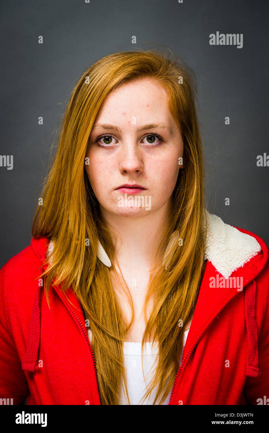 A moody sulky 16, 17 year old red haired freckle faced teenage girl, UK Stock Photo