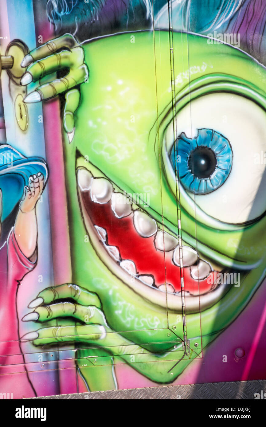 detail of one eyed green monster on booth on Bournemouth Pier in February Stock Photo