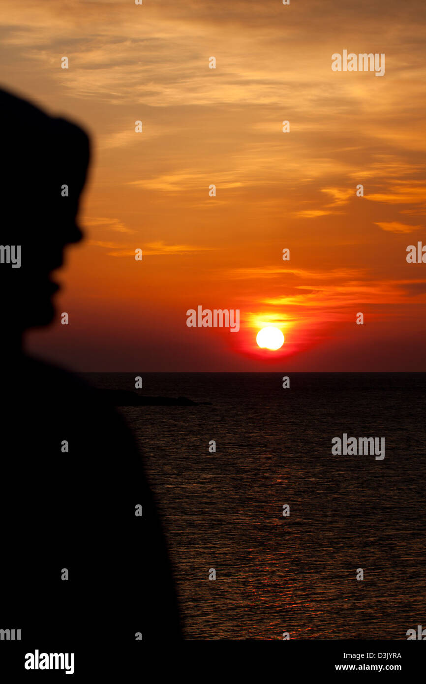 A man standing in front of a sunset Stock Photo - Alamy