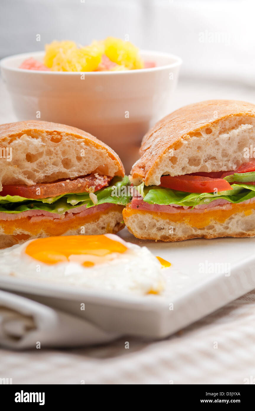 fresh ciabatta panini sandwich with eggs tomato lettuce Stock Photo