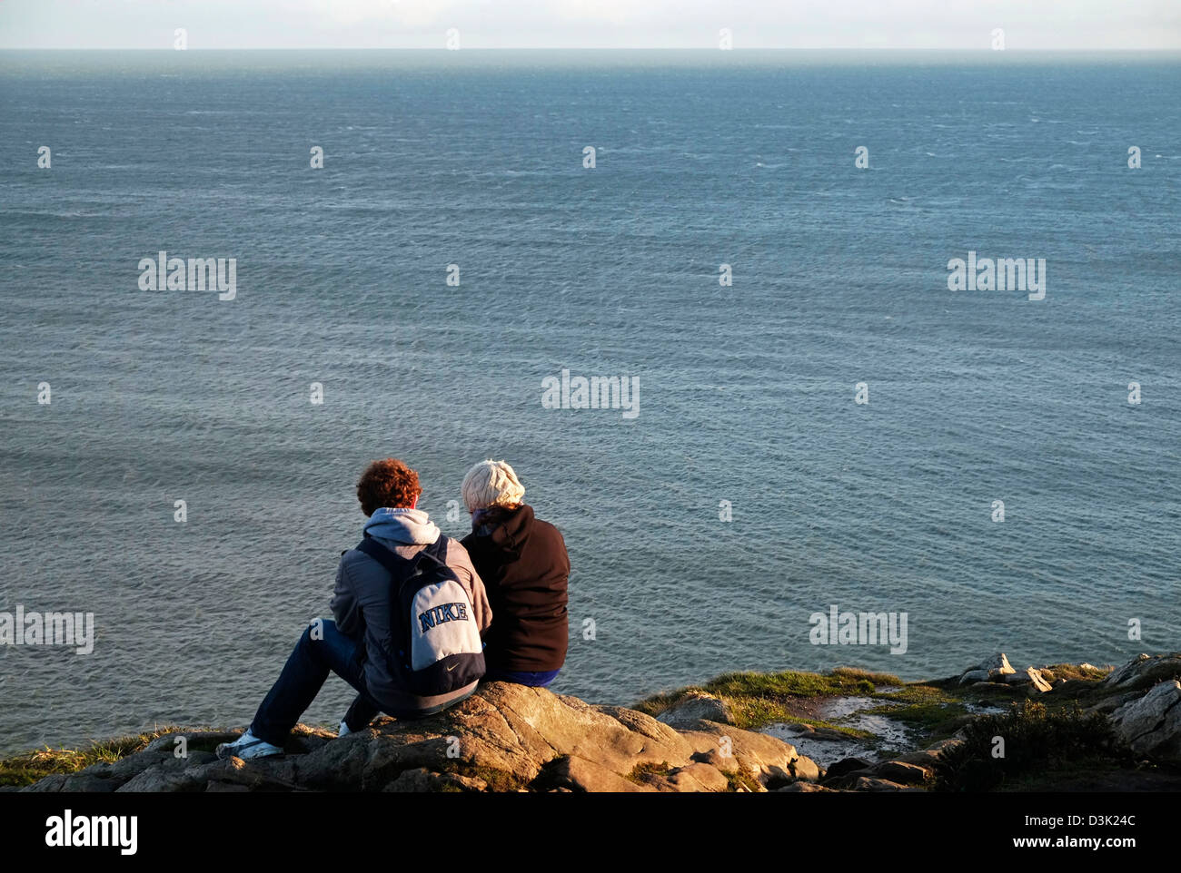 A couple take in the Atmospheric view from Howth Hill, Fingal Dublin Ireland Stock Photo