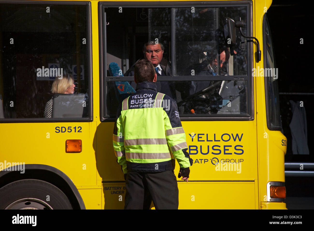 Yellow buses man talking to driver of Yellow Buses bus stopped at bus stop in Bournemouth Town Centre in February Stock Photo