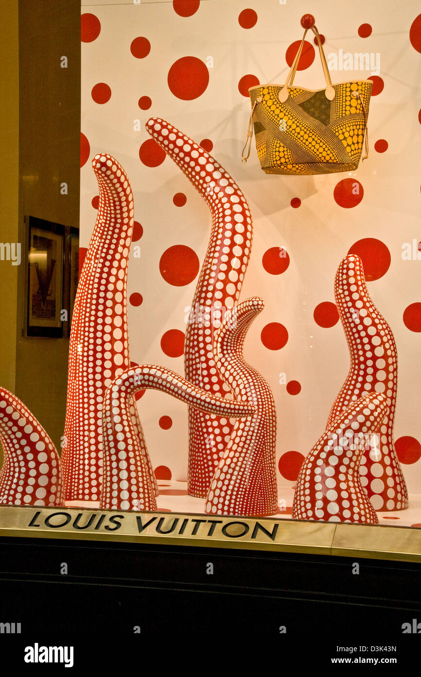 Yellow bag in a Louis Vuitton boutique illuminated window display Galleria Vittorio Emanuele II Milan Lombardy Italy Europe Stock Photo