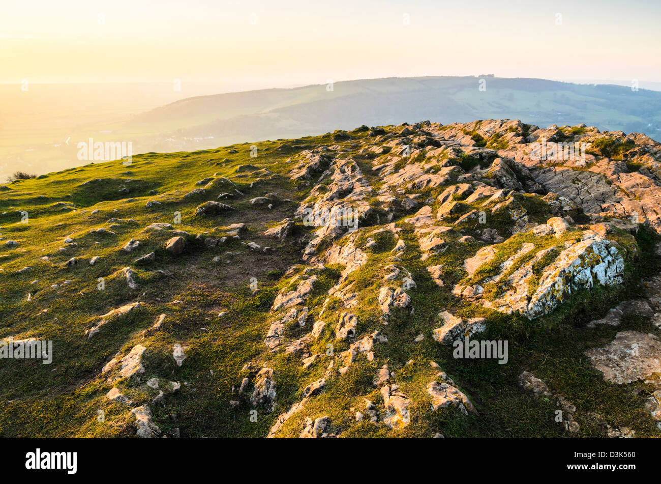 Limestone outcrop at Crook Peak in the Mendip Hills with Bleadon Hill in the distance. Axbridge, Somerset, England. Stock Photo