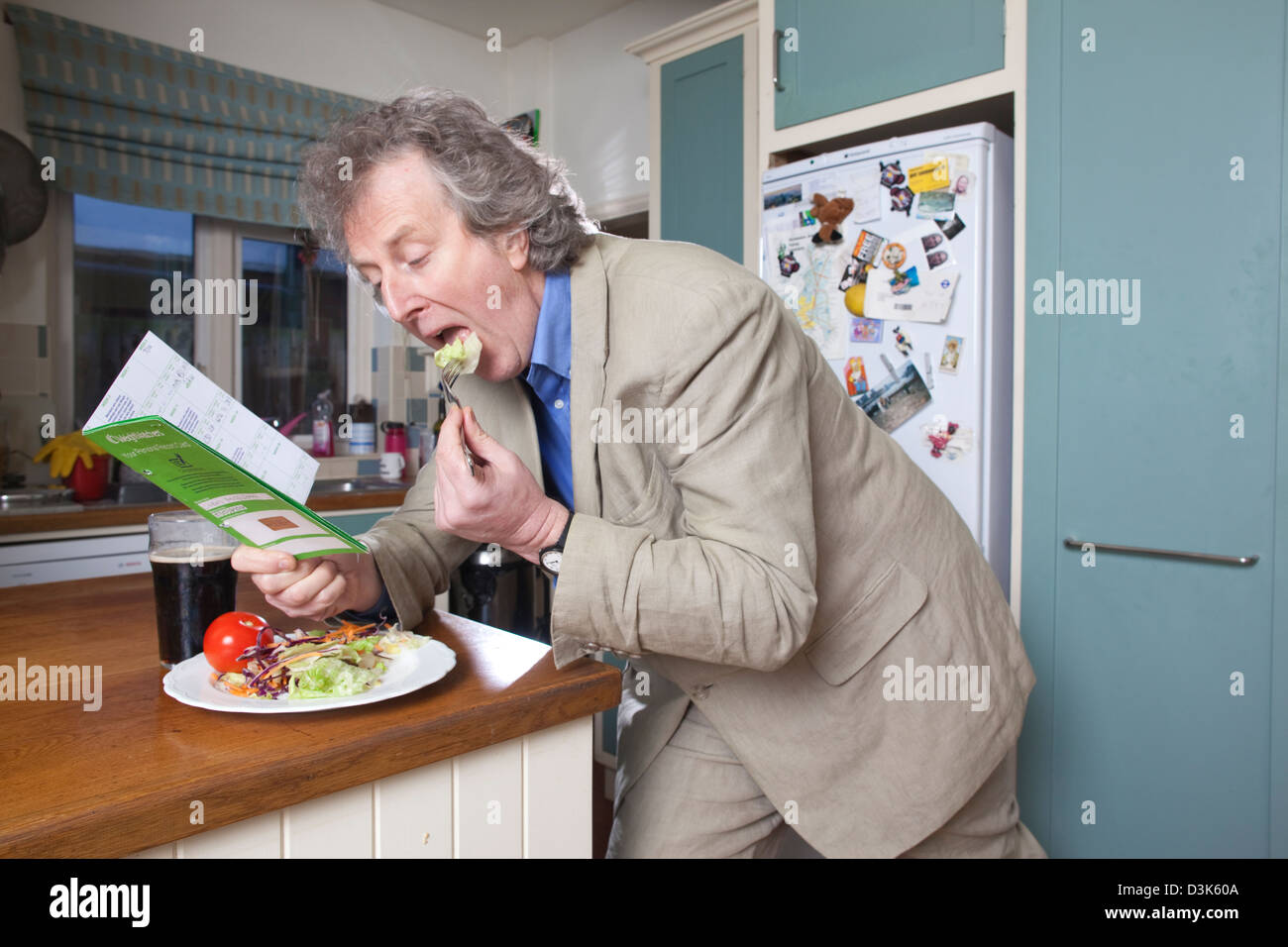Middle aged man following his Weight Watchers personal record card requirements for his diet. Stock Photo