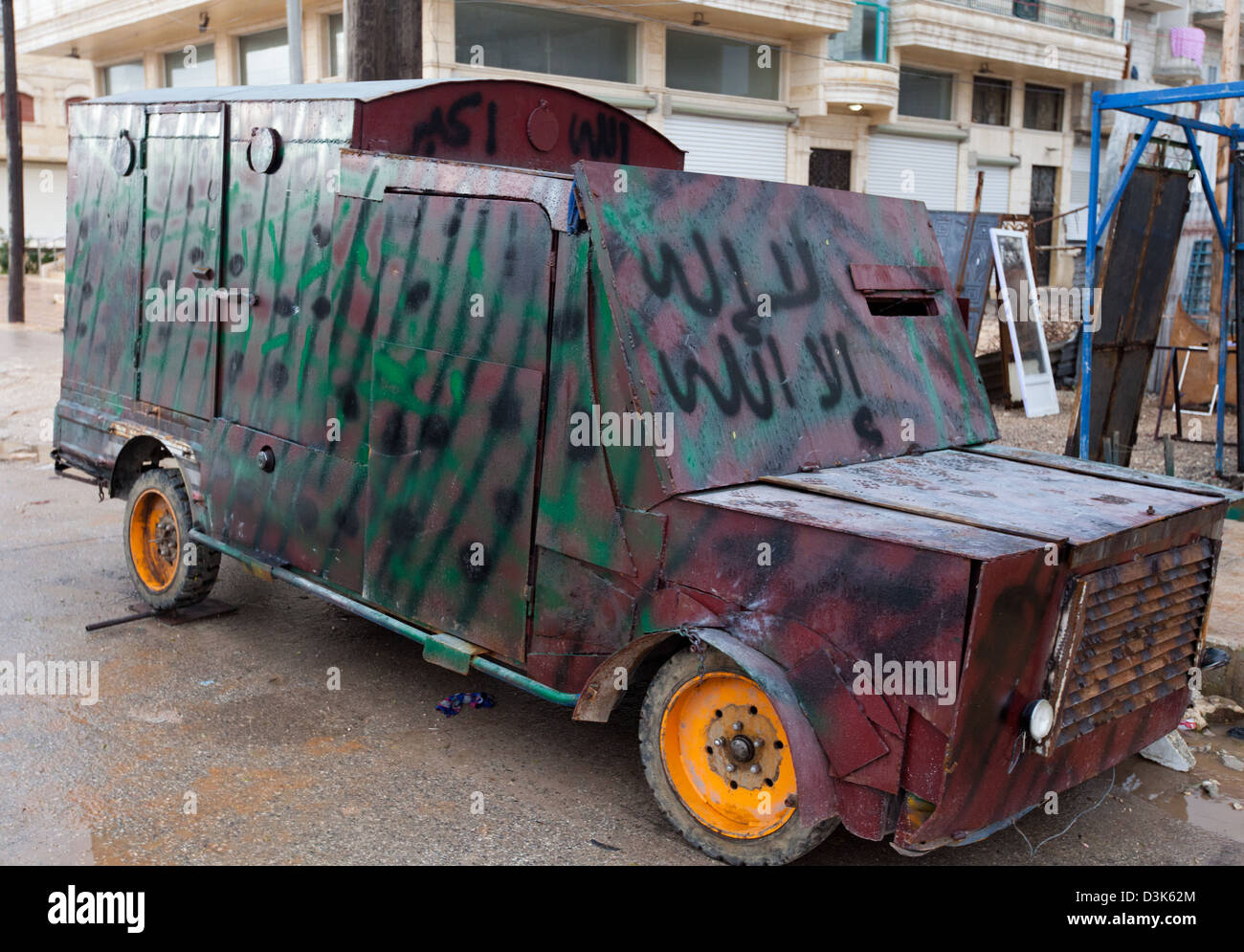 Free Syrian Army fighters inspect a homemade tank. It was designed for rescue of wounded people in the line of a sniper. Heavy a Stock Photo