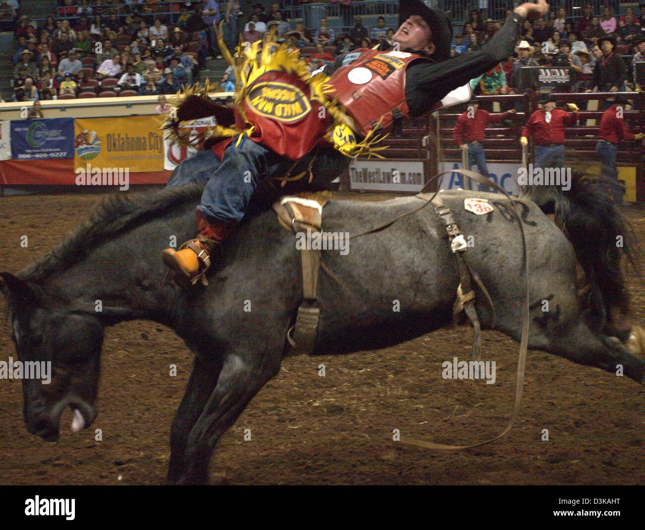 Cowboy riding bucking bronco horse during the National Finals Rodeo in ...
