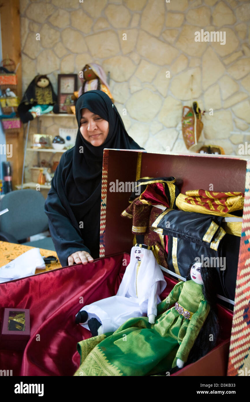 A doll maker displays her handiwork at the government sponsored Al-Jasara Handicraft Centre in Manama, Bahrain. Stock Photo