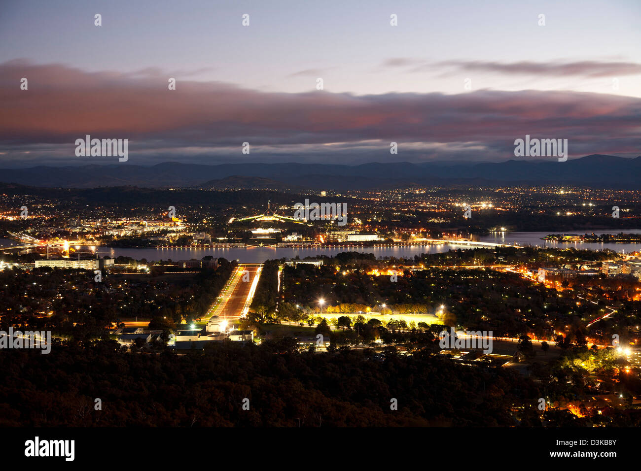 Night-time view of Anzac Parade Lake Burley Griffin and Canberra Australia Stock Photo