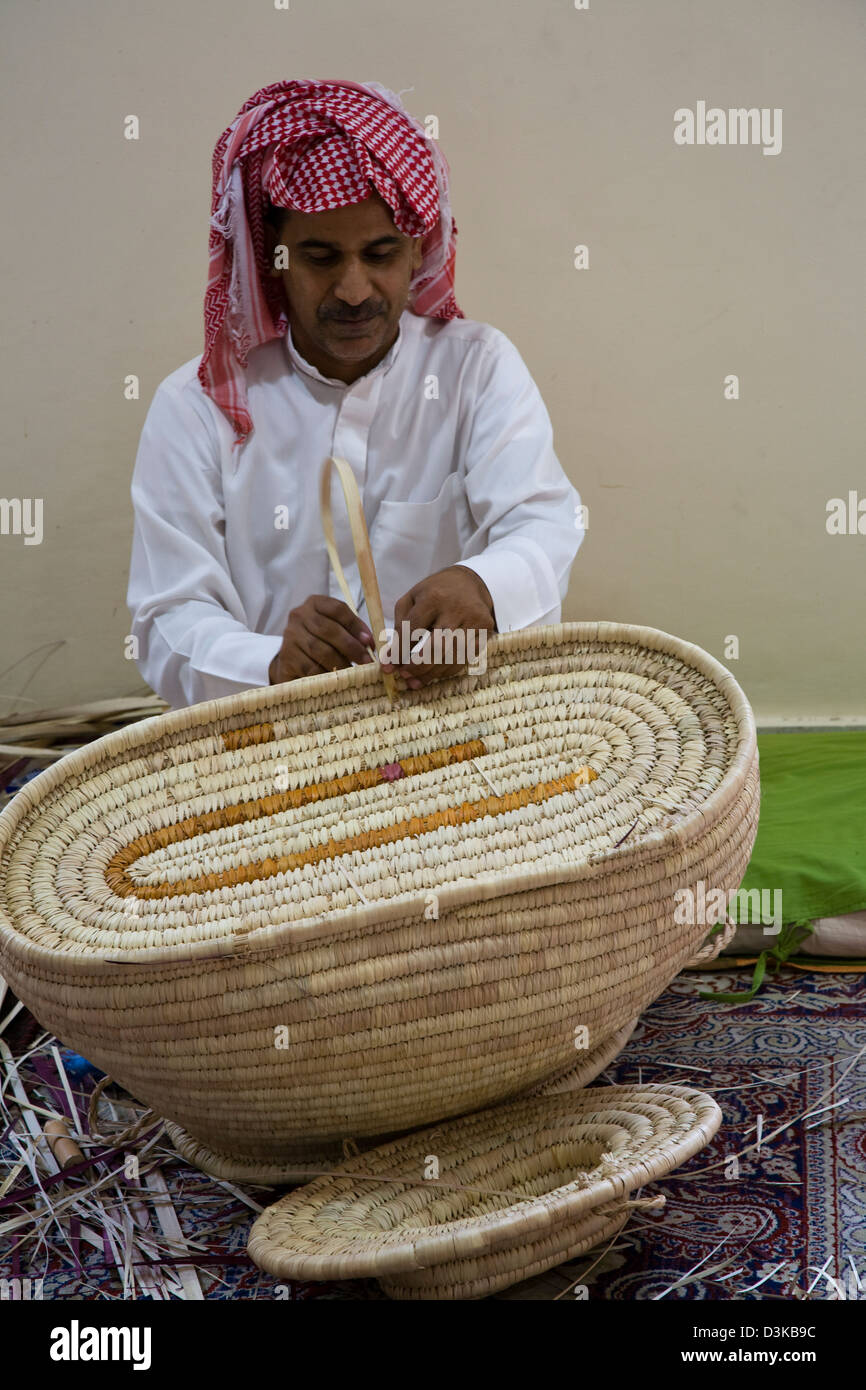 A basket maker demonstrates his skills at the government sponsored Al-Jasara Handicraft Centre in Manama, Bahrain. Stock Photo