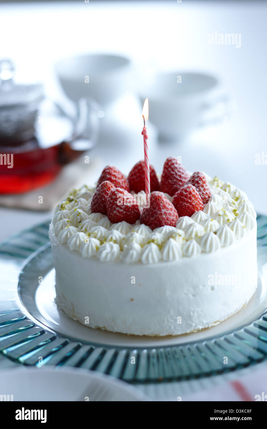 Strawberry shortcake with candle on a glass plate Stock Photo - Alamy