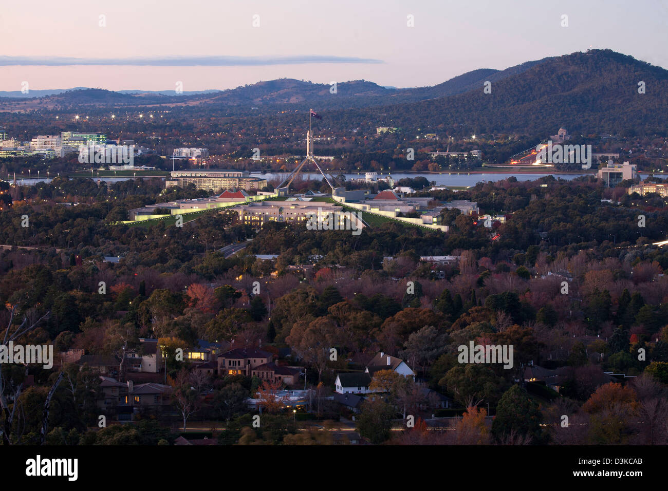 Sunset over  Parliament House Canberra Australia surrounded by autumn colours Stock Photo