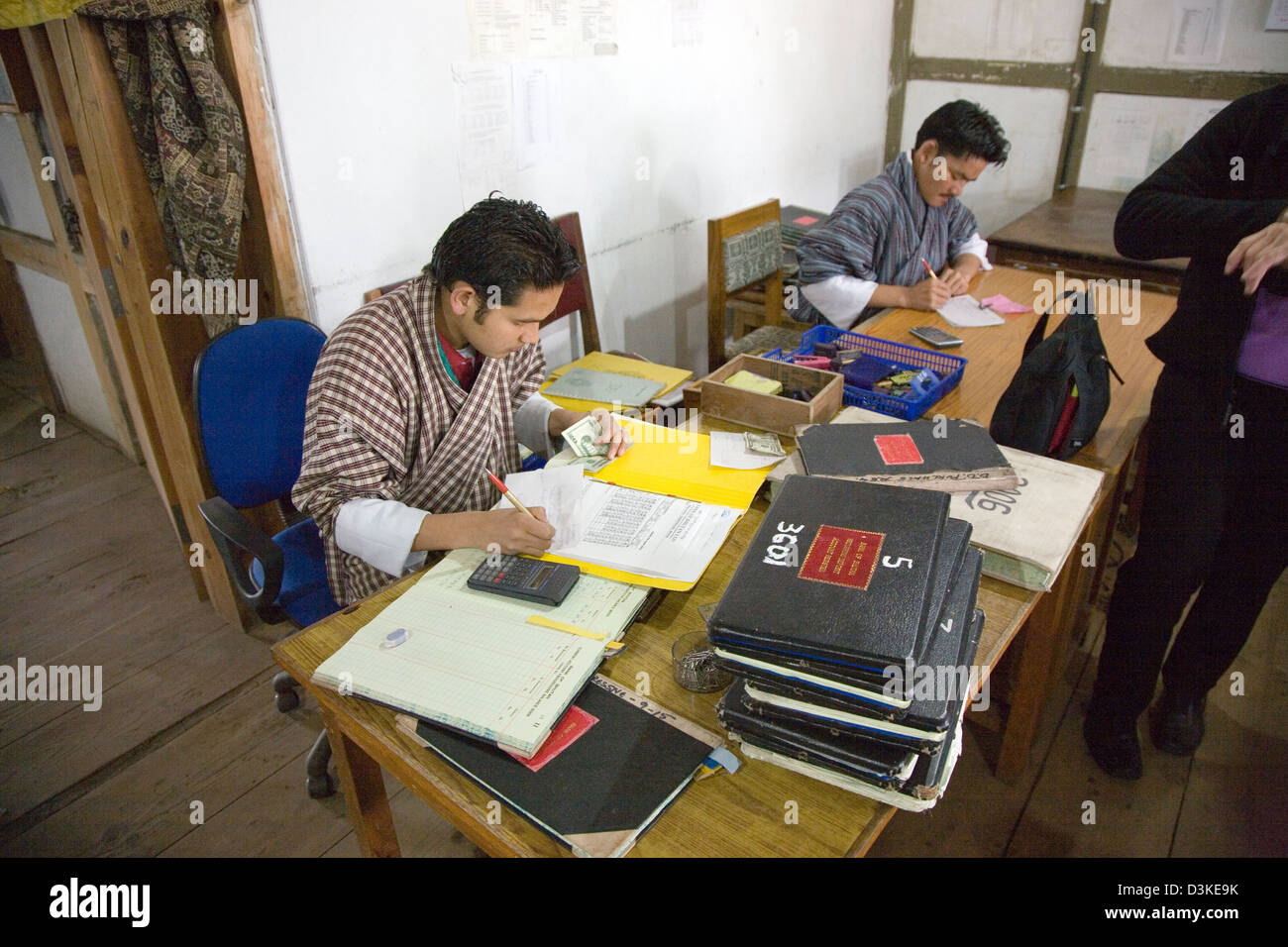 Recording in ledger books at a rural Bank of Bhutan branch in Dakar, Bhutan, Asia Stock Photo