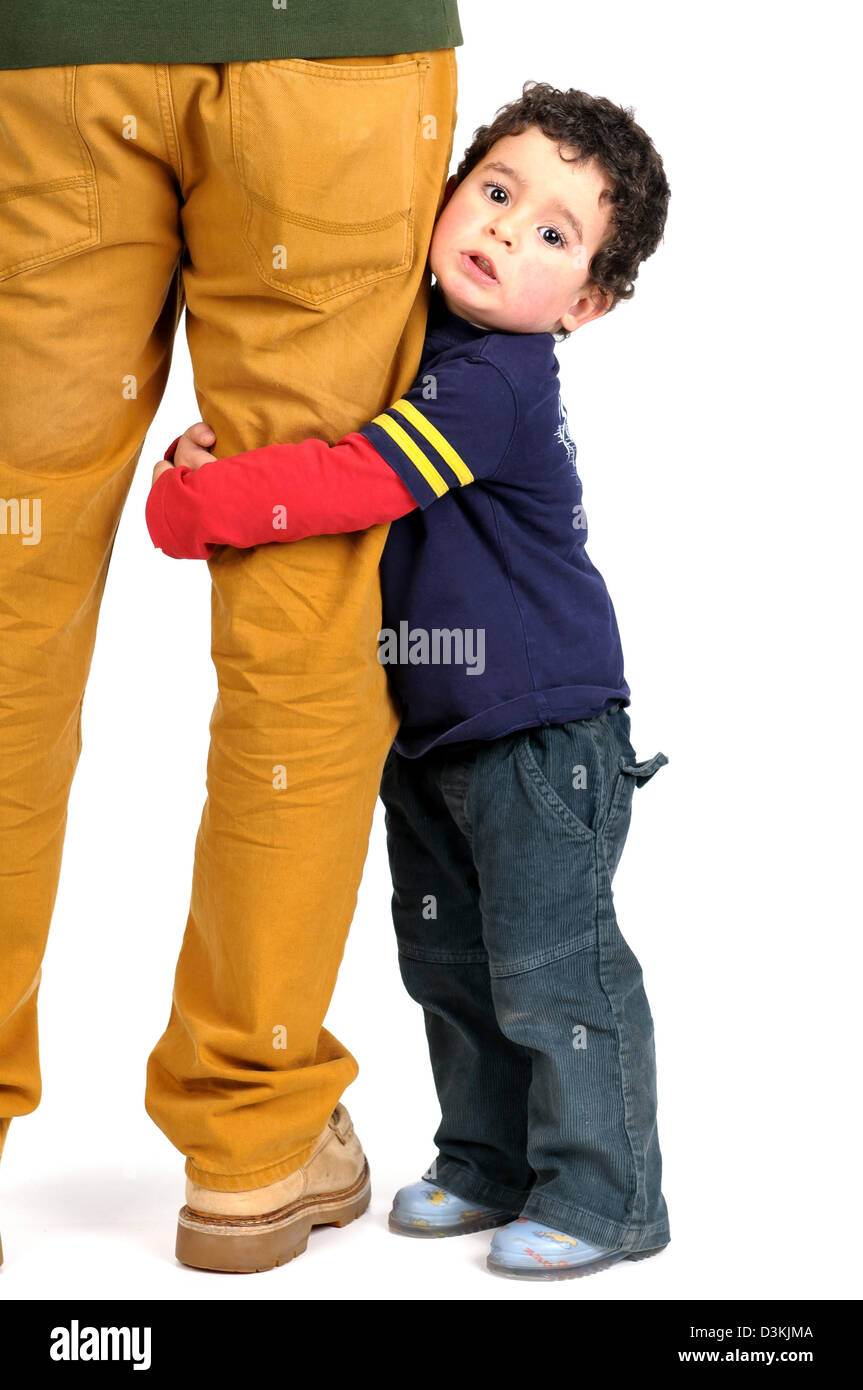 Young boy hugging his father's leg Stock Photo