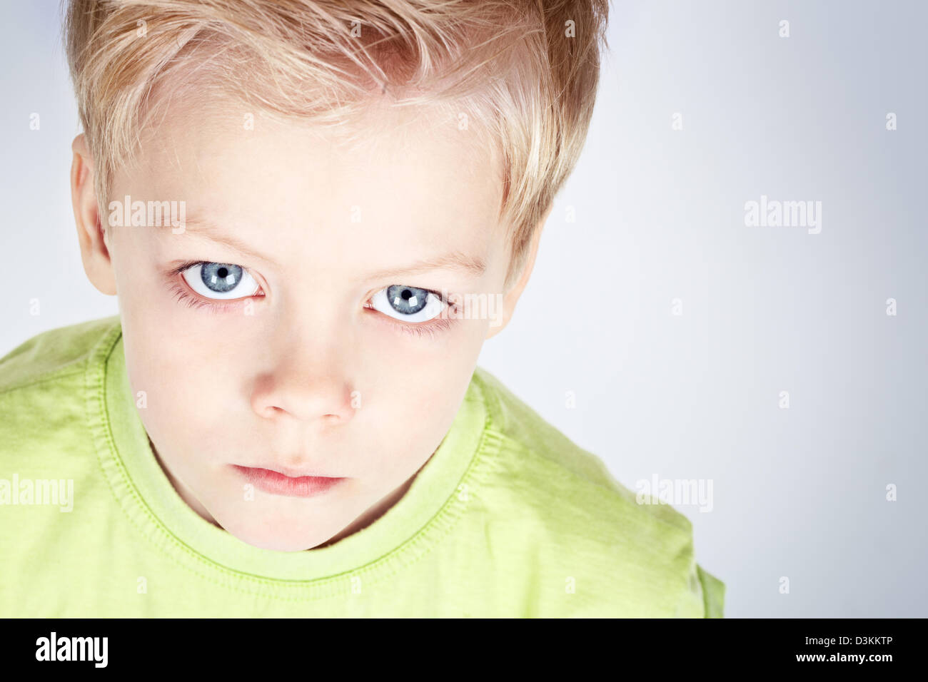 Closeup portrait of a charming blueeyed boy gazing at camera Stock