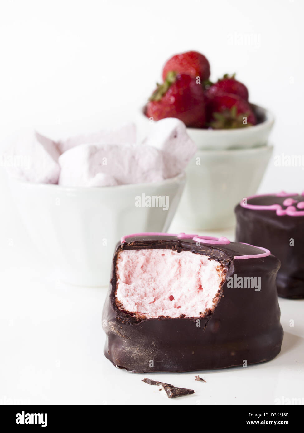 Gourmet chocolate covered strawberry marshmallows on white background ...