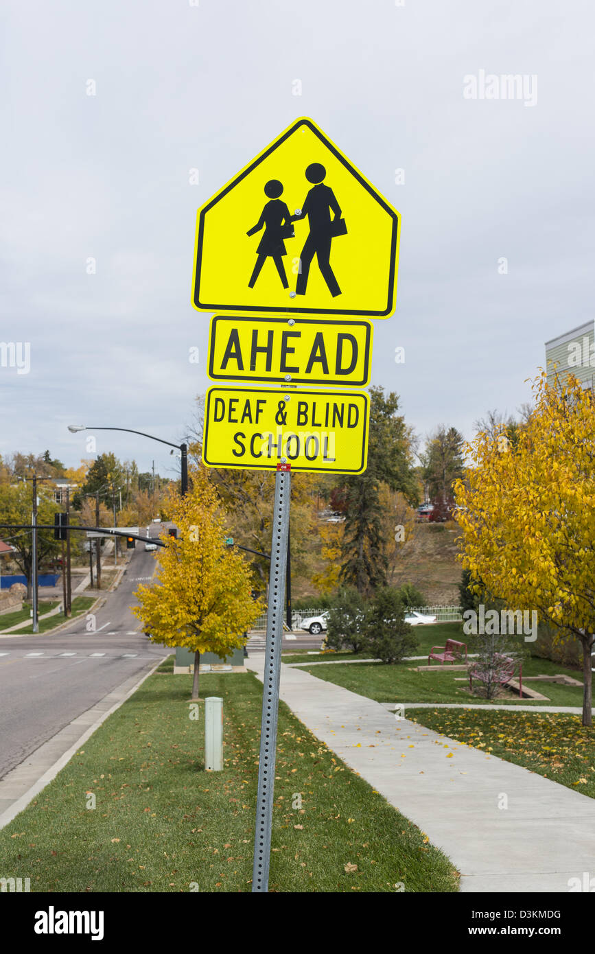 Traffic sign warning for a deaf and blind school ahead Stock Photo