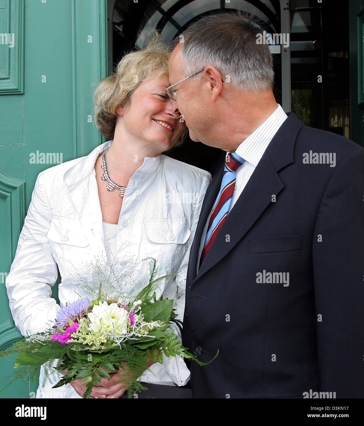 (dpa) - German Minister of Finance Hans Eichel (SPD) and his newly wed long-term girlfriend Gabriela Wolff (L) look at each other and smile after their wedding ceremony in Kassel, Germany, 27 July 2005. The short ceremony at the registrar's office took place amongst the closest family circle at Chateau Bellevue, witnesses said. It is the second marriage for 63-year old Eichel, form Stock Photo