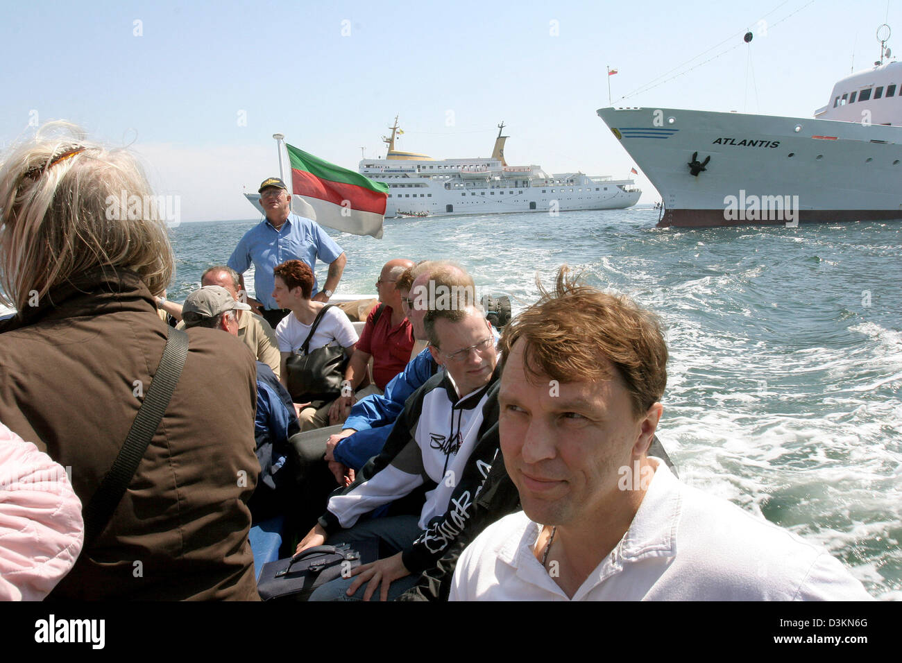 (dpa) - The picture dated 24 June 2005 shows disembarking tourists offshore Helgoland, Germany. Since bigger ships have to moor offshore, Visitors are ferried across to the island by smaller boats. Photo: Uwe Zucchi Stock Photo