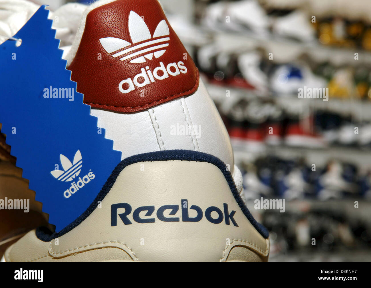 dpa) - The picture shows an Adidas sneaker on top of a Reebok sneaker in a  sporting goods store in Munich, Germany, Wednesday 03 August 2005. In order  to bridge the gap