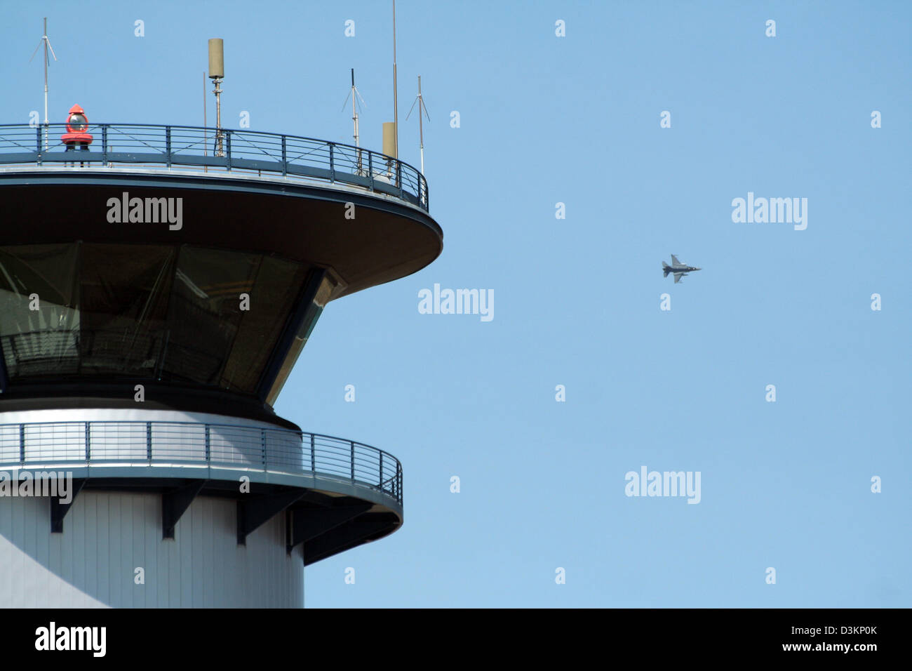 Darwin airport control tower and an F-16 fighter jet flyby Stock Photo