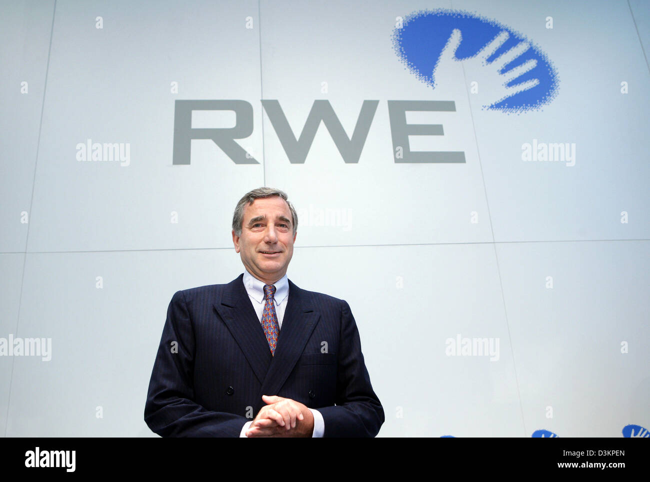 (dpa) - Harry Roels, chairman of energy company RWE, stands underneath the company logo during a press conference in Essen, Germany, Thursday, 11 August 2005. RWE continued the positive trend in business results from the first half term. The operational results increased in comparison to the previous year values by five percent to 3,455 million euros. Photo: Rolf Vennenbernd Stock Photo