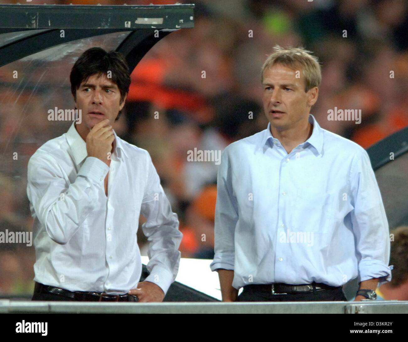 (dpa) - The picture shows head coach of the German national soccer team Juergen Klinsmann (R) and his assistant Joachim Loew during the friendly match Netherlands vs Germany at the 'De Kuip' stadium in Rotterdam, Netherlands, 17 August 2005. The game ended in a 2-2 draw. Photo: Bernd Weissbrod Stock Photo
