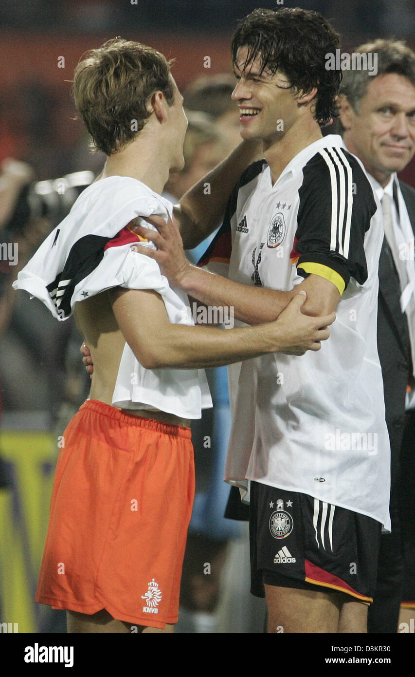(dpa) - Captain of the German national soccer team Michael Ballack (R) and Dutch national player Arjen Robben embrace after the friendly match Netherlands vs Germany at the 'De Kuip' stadium in Rotterdam, Netherlands, 17 August 2005. The game ended in a 2-2 draw. Photo: Frank May Stock Photo
