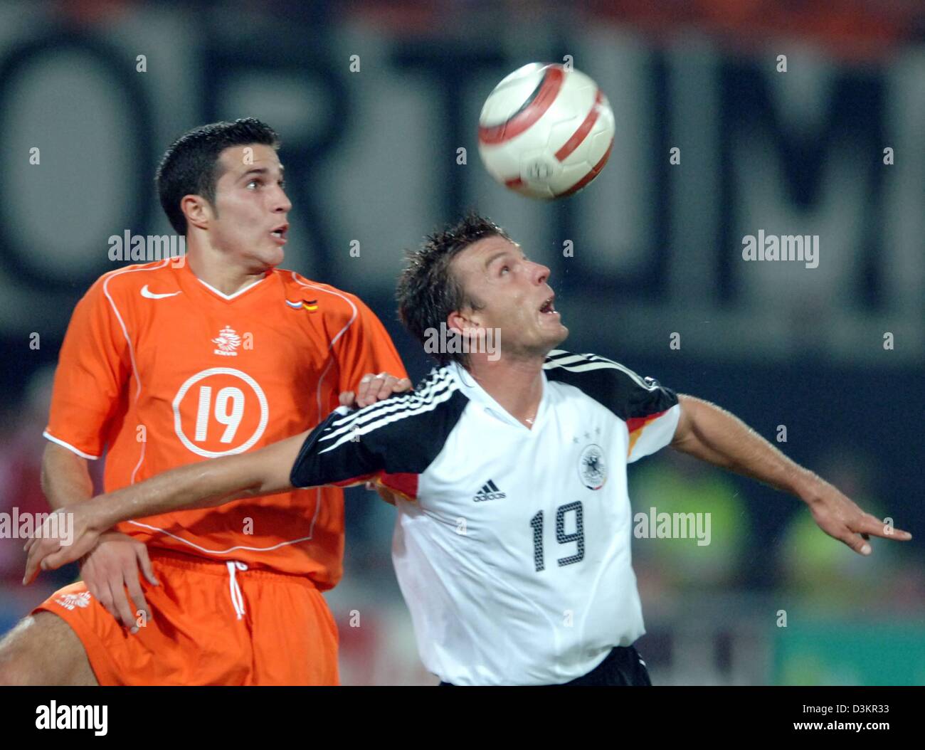 (dpa) - German national soccer player Bernd Schneider (R) fights for the ball with Dutch national player Robin van Persie during the friendly match Netherlands vs Germany at the 'De Kuip' stadium in Rotterdam, Netherlands, 17 August 2005. The game ended in a 2-2 draw. Photo: Bernd Weissbrod Stock Photo