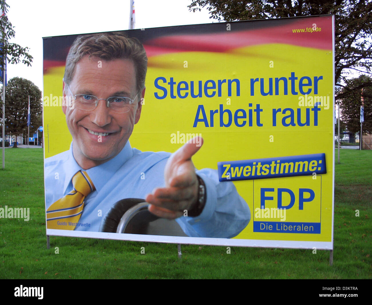 (dpa) - Guido Westerwelle, chairman of the Liberal Democratic Party (FDP) is featured on an election poster, which reads ' Tax down jobs up. Second vote for FDP' pictured ahead of the general elections for the German Bundestag parliament on 18 September 2005, in the state of North Rhine Westphalia, Germany on 27 August 2005. Photo: Wolfgang Moucha Stock Photo