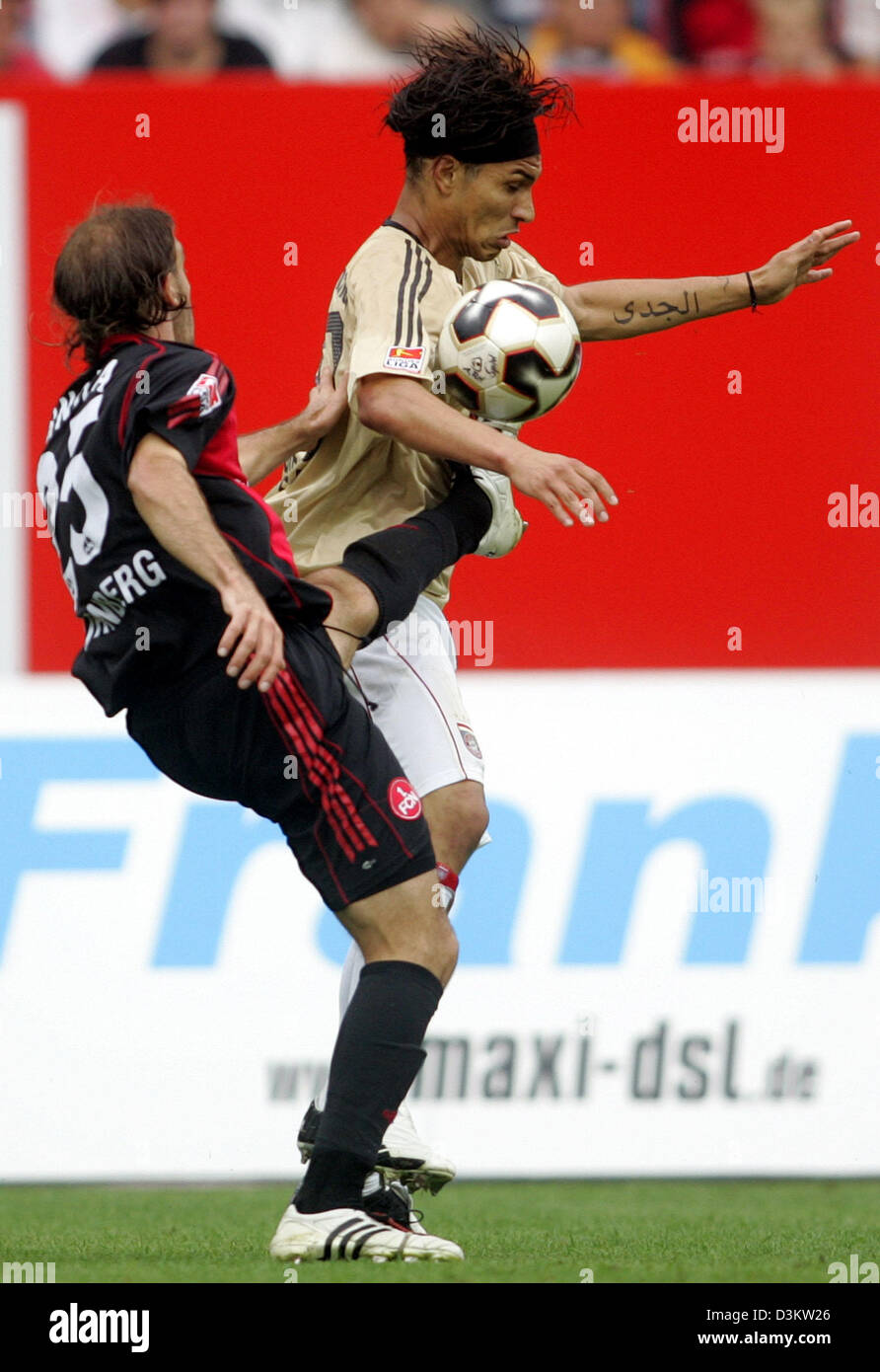 (dpa) - Nuremberg's Javier Horacio Pinola (L) struggles for the ball with Munich's player Paolo Guerrero  in the Bundesliga soccer match between 1st FC Nuernberg vs FC Bayern Munich at the Franken soccer stadium in Nuremberg, Germany, Saturday, 10 September 2005. (ATTENTION: New blocking period! The German Soccer League (DFL) prohibits the publication and further use of the picture Stock Photo
